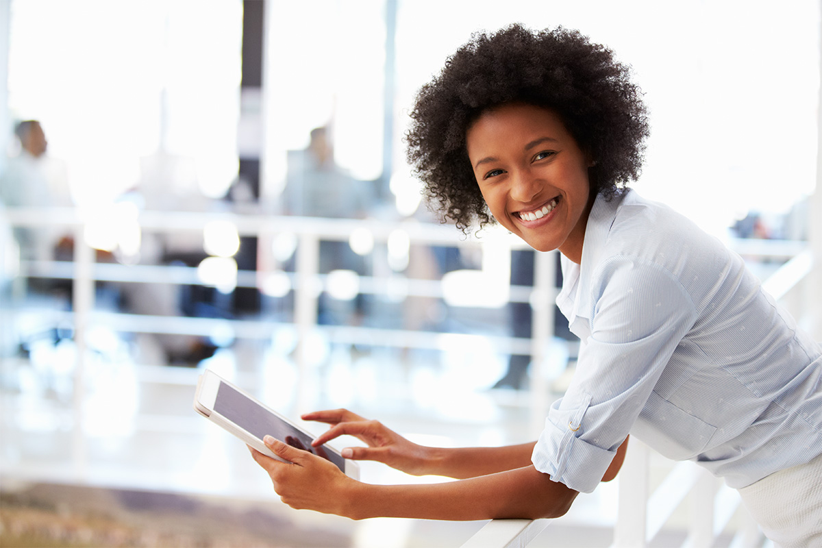 woman on tablet smiling