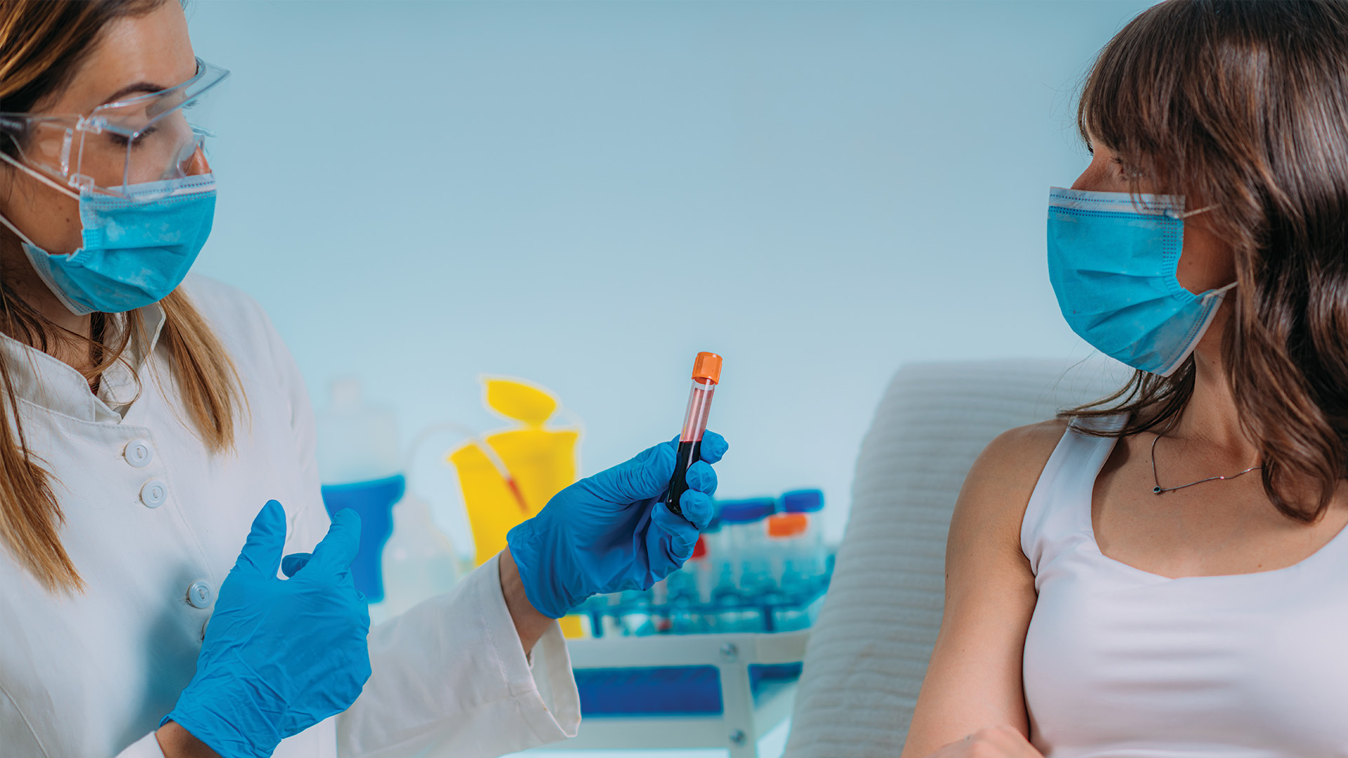 phlebotomist drawing blood from a patient